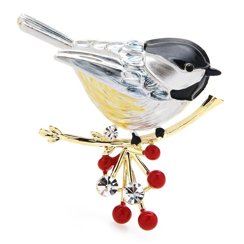 A bird sitting on a branch - crystal broochBrooches