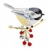 A bird sitting on a branch - crystal broochBrooches