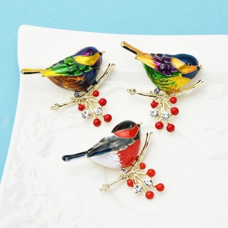 A bird sitting on a branch - crystal broochBrooches