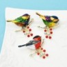 A bird sitting on a branch - crystal broochBrooches