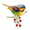 A bird sitting on a branch - crystal broochBrooches