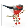 A bird sitting on a branch - crystal broochBrooches