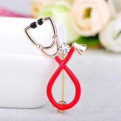 Stethoscope shaped brooch with crystalBrooches