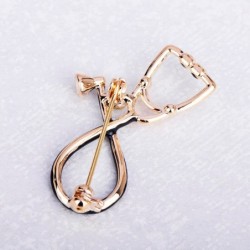 Stethoscope shaped brooch with crystalBrooches