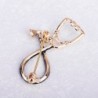 Stethoscope shaped brooch with crystalBrooches