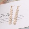 Elegant long golden earrings - geometric metal with pearlsEarrings