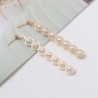 Elegant long golden earrings - geometric metal with pearlsEarrings