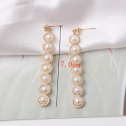 Elegant long golden earrings - geometric metal with pearlsEarrings