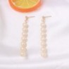 Elegant long golden earrings - geometric metal with pearlsEarrings