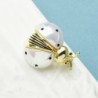 White / gold ladybug broochBrooches