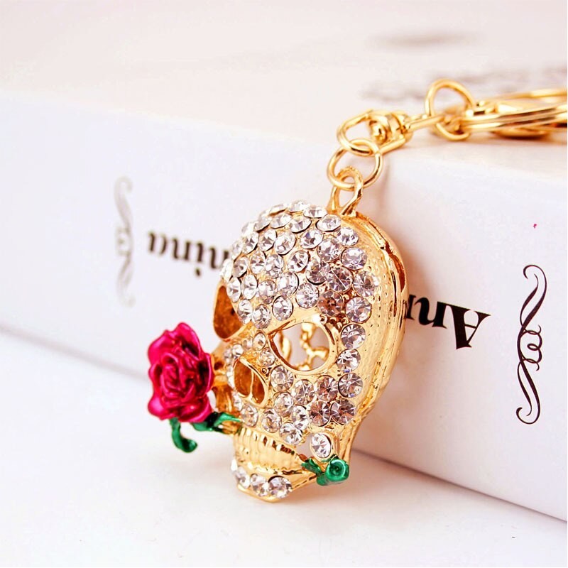 Golden crystal skull with rose - keychainKeyrings