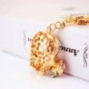 Golden crystal skull with rose - keychainKeyrings