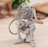 Skeleton sitting on the toilet - rubber keychainKeyrings