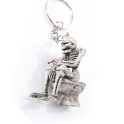 Skeleton sitting on the toilet - rubber keychainKeyrings