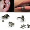 Body piercing with skull handEarrings